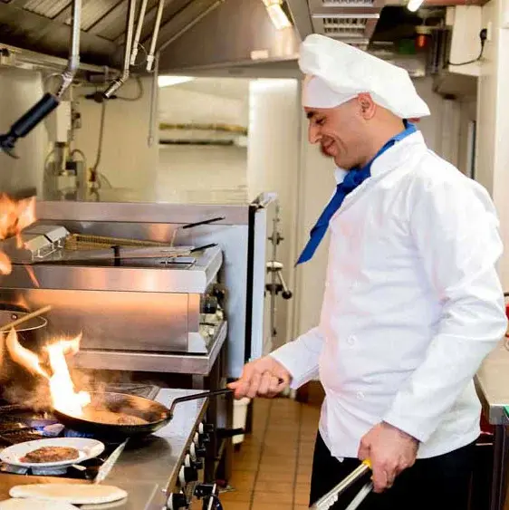 The Oaks Chef Created Meals, chef frying a dish.