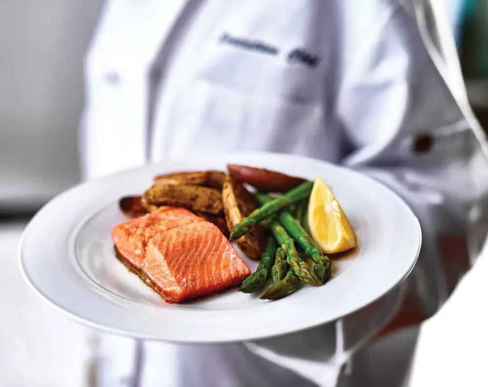The Oaks Chef Created Meals, chef delivering a finished dish.
