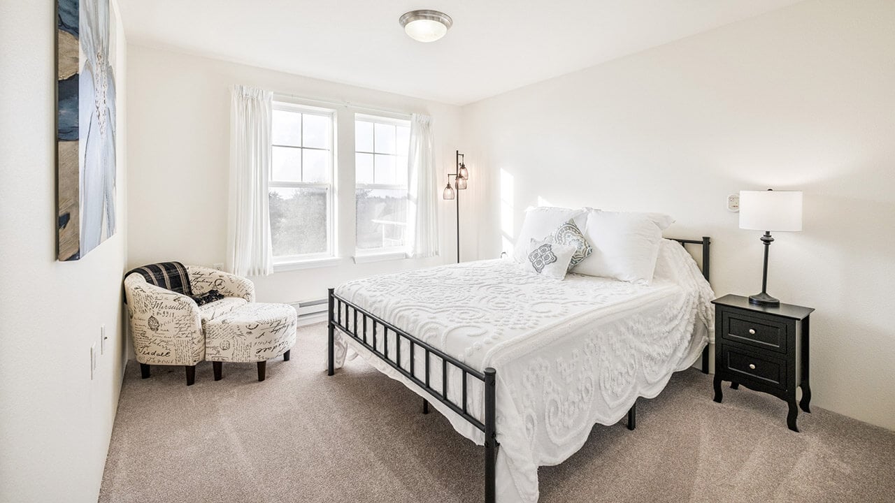 A furnished bedroom in a The Oaks apartment